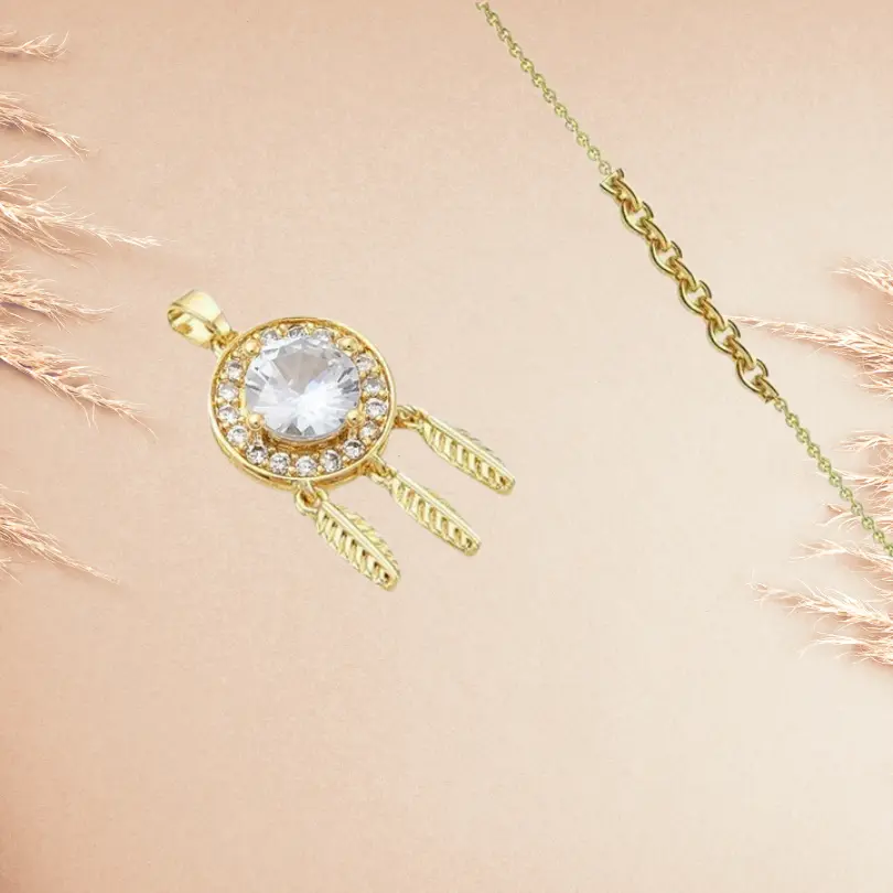 Collier Attrape Rêve 5 Pendentif attrape-rêves doré avec zirconium blanc central, entouré de strass et plumes, sur chaîne dorée